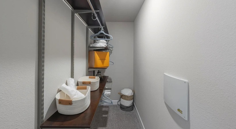 a room with a shelf and a table with objects on it
