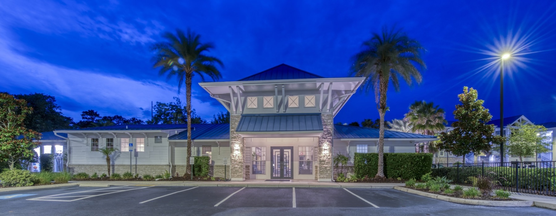 the exterior of a building and a parking lot at night