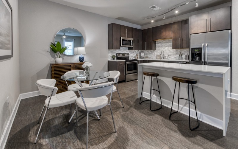a dining area near a kitchen and a bar