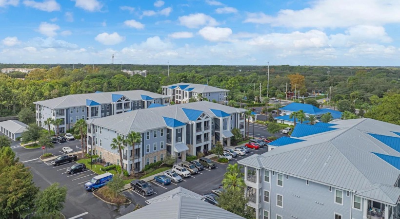 a group of buildings with trees in the background