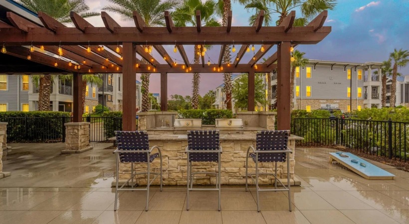 a patio with chairs and a pool